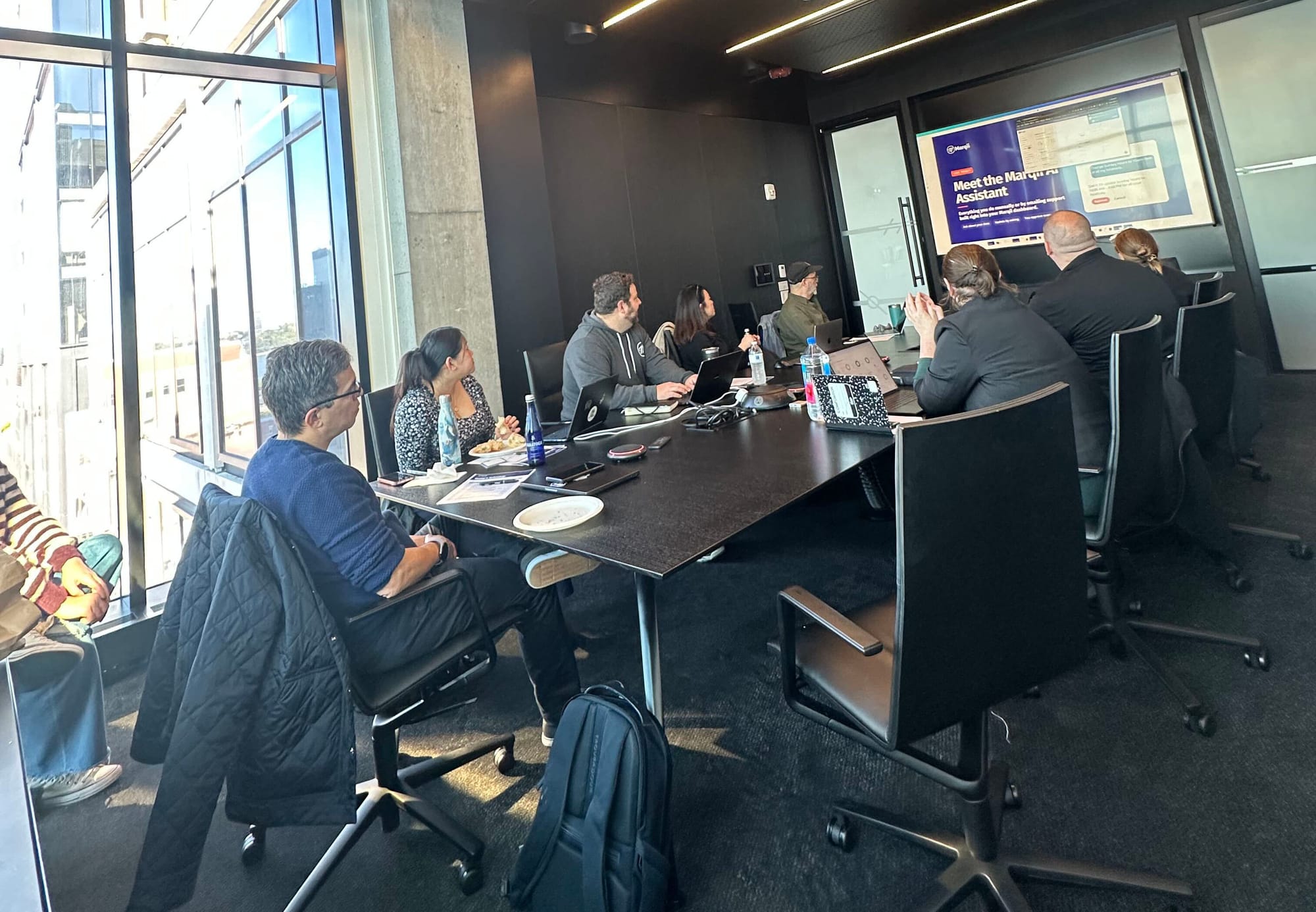 Workshop attendees watching a first-look presentation of Marqii's new in-app AI assistant