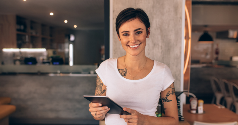 restaurant worker holding an ipad